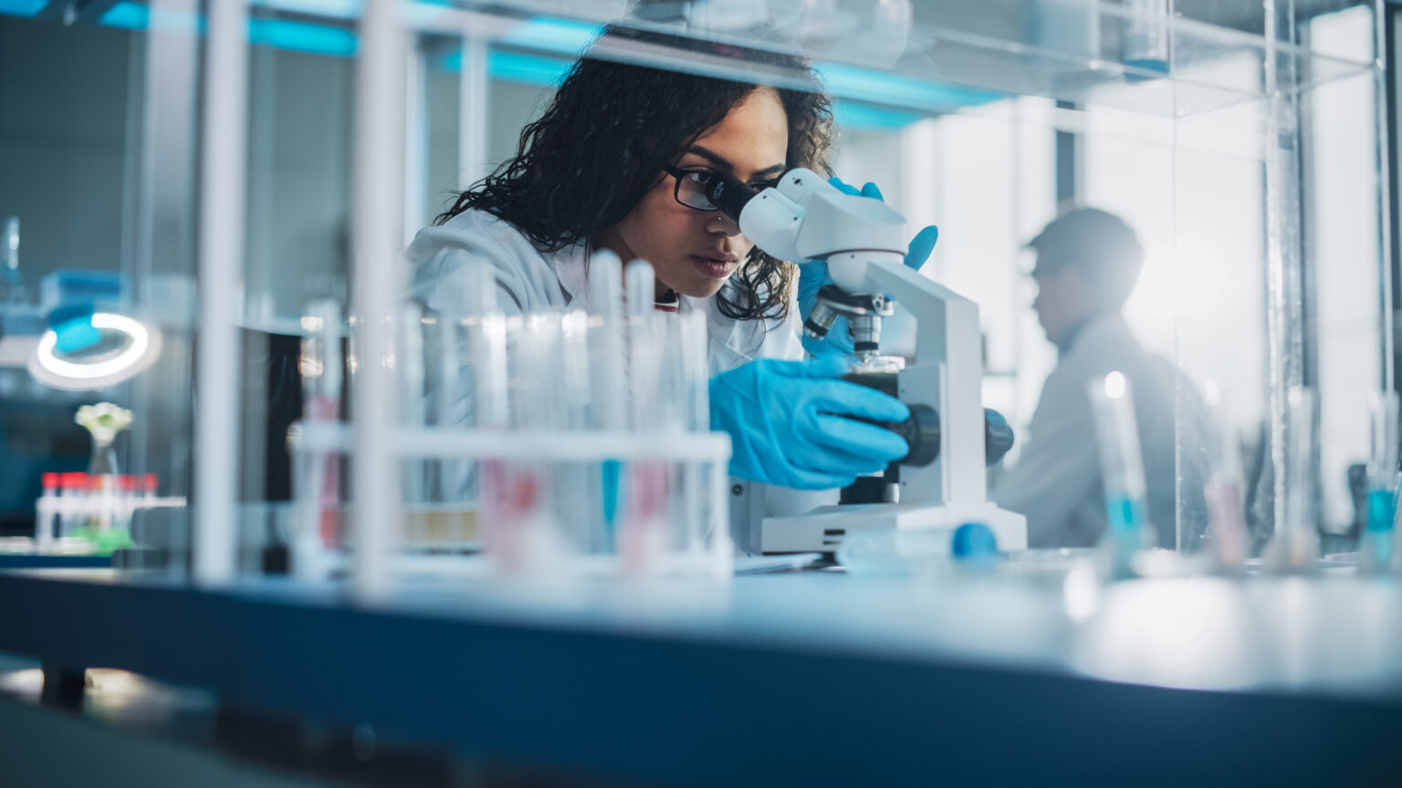 Medical Science Laboratory researcher using a microscope